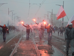 Niecodzienny widok: operator kamery odpala racę solidaryzując się z uczestnikami Marszu Niepodległości