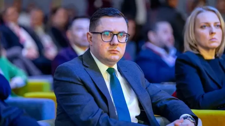 Miłosz Motyka siedzi i patrzy w dal