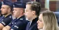 Sebastian M. na sali sądowej. W tle policjanci i kobieta