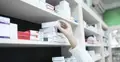 ręka farmaceuty sięgającego po leki
