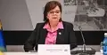 Izabela Leszczyna na konferencji, obok stoi mikrofon i woda